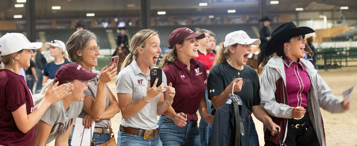 W Texas A and M cheer on their team.